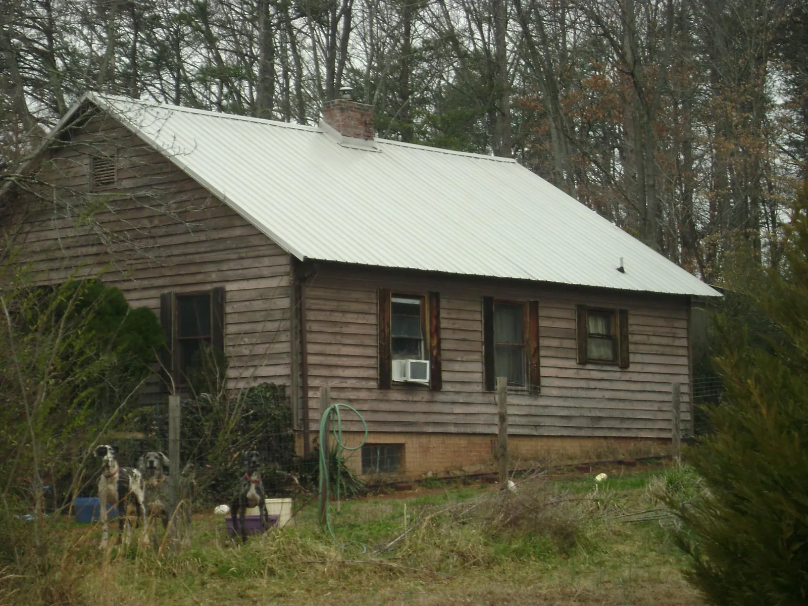 White metal roof on an old wood sided farmhouse, from a Metal Roof Installation job in East Canaan